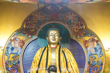 Gilded Buddha statue close-up in datsan Damba Braibunling,Buddha statue in a Buddhist temple.