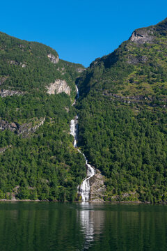 Water dropping down from the Bringefossen (a.k.a. Gomsdalsfossen) waterfall into the Geiranger Fjord, Norway