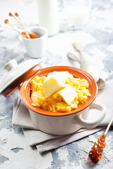porridge with butter in plate on rustic table