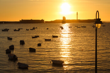 sunset at the pier in Cadiz, Spain - obrazy, fototapety, plakaty