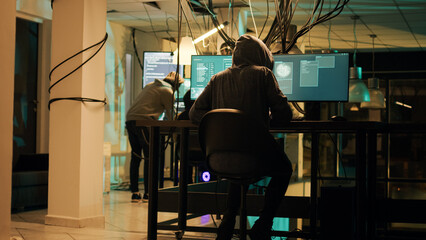 Woman hacker planning phishing and espionage at night, trying to break server firewall for...