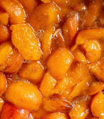 Fresh apricots in syrup with vanilla seeds ready to be cooked into apricot jam.