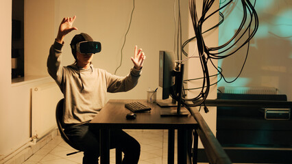 Young skilled thief working with vr glasses to hack firewall encryption, using virtual reality headset to crack government system. Male hacker breaking network with malware and virus.