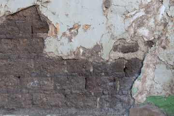 wall with worn plaster and brick background