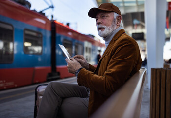 Senior man waiting for train
