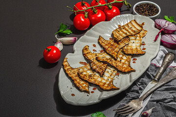 Fried slices Pleurotus eryngii mushrooms with balsamic sauce and sesame seeds. Spices and herbs