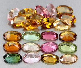 Natural beautiful gemstones multicolored tourmaline on a gray background