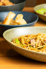 Various dishes of Asian food. Pork noodles, spring rolls. Selective focus. High quality photo