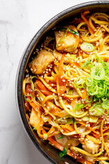 Top view of bowl with Chinese noodles with pork and vegetables. High quality photo