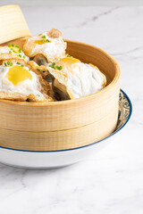 Beef and fried egg dumpling in bamboo steamer box. High quality photo