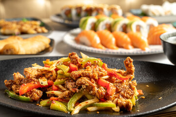 Selective focus on spicy chicken strips on various asian dishes. High quality photo