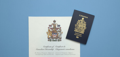 A Canadian Passport on a Canadian Citizenship Certificate against a light blue background