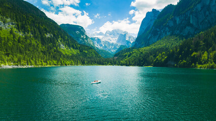 Gosausee, a beautiful lake and a white boat with moutains in Austria.