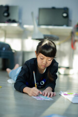 Little girl doing homework, kid writing paper, education concept