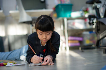 Little girl doing homework, kid writing paper, education concept