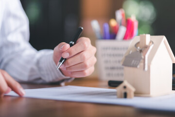 Businessman checking documents to sign financial contract,Management of business documents and agreements, signing of business contracts, approval of contract documents or warranty certificates.