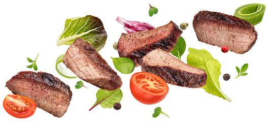 Falling steak salad ingredients isolated on white background