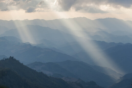 View from summit of Phoufa with sunbeams illuminating hills, Phongsaly, Laos