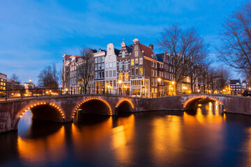 Naklejka premium Amsterdam canal at twilight in winter, Amsterdam is the capital and most populous city in Netherlands.