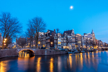 Obraz premium Amsterdam canal at twilight in winter, Amsterdam is the capital and most populous city in Netherlands.