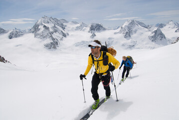 A group of skiers climb toward the Col Nord des Portons enroute to the Vignettes Hut on the Haute Route, Switzerland.