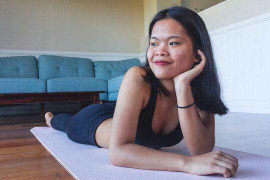 Young girl laying down on mat yoga after practicing yoga