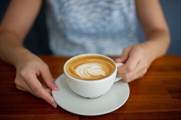 closeup hand drinking hot coffee, relax time