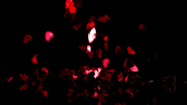 Animation of red hearts falling over black background