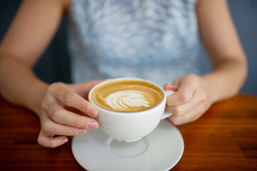 closeup hand drinking hot coffee, relax time