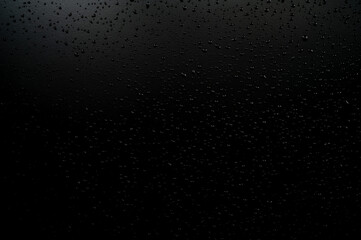 Water droplets on the floor with black background