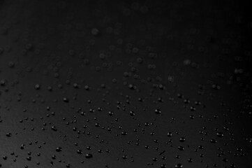 Water droplets on the floor with black background