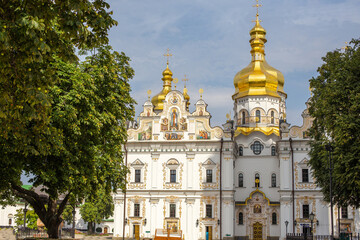 Fototapeta na wymiar Kyiv Pechersk Lavra, Holy Dormition cathedral. Main temple of Kyiv Monastery of Caves, Ukraine. Front view, with old authentic masonry. UNESCO World Heritage Site
