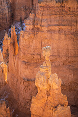 Winter scenery from Bryce Canyon National Park with brilliantly colored orange cliffs and a touch of  snow