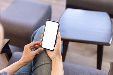 cell phone blank white screen mockup.hand holding texting using mobile on desk at office.background empty space for advertise.work people contact marketing business,technology