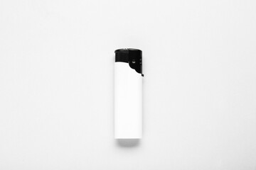 Stylish small pocket lighter on white background, top view
