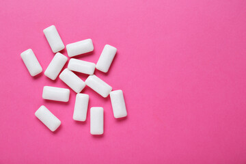 Tasty white chewing gums on pink background, flat lay. Space for text © New Africa