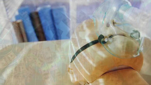 Animation of graph and dollar bills over close-up of cpr dummy with oxygen mask on stretcher