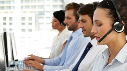 Animation of snowfall over diverse customer service representatives working on computer in office - Powered by Adobe