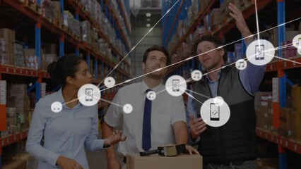 Animation of connected icons over multiracial coworkers discussing in warehouse - Powered by Adobe