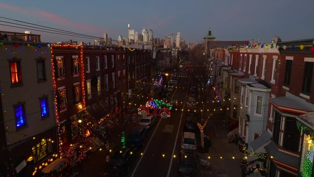 Outdoor Christmas light display on South 13th St. Philadelphia skyline at night. Aerial holiday theme shot.