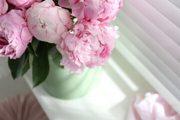 Bouquet of beautiful peonies on window sill, closeup. Space for text