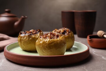 Baked apples with delicious filling served on grey table