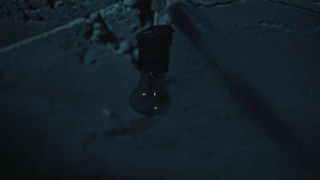 Old garage has lamp with blue light. Atmosphere dark place full of smoke.