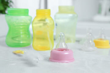 Baby bottles and nipples after washing on white countertop in kitchen