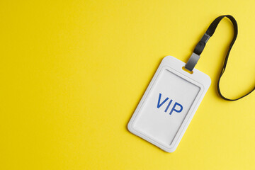 Vip badge on yellow background, top view. Space for text