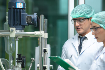 Scientist wearing glasses and gloves checking hemp plants in a marijuana farm, Marijuana research for CBD oil, alternative herbal medicine concept, pharmaceutical industry laboratory for business