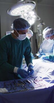 Vertical Video Of Diverse Surgeons With Face Masks During Surgery