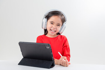 little girl asia cute put on headphones have video call distant class with teacher using laptop,  study online on computer, homeschooling concept