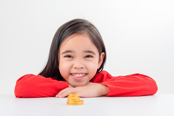 Little Asian girl saving money in a piggy bank, learning about saving, Kid save money for future education. Money, finances, insurance, and people concept