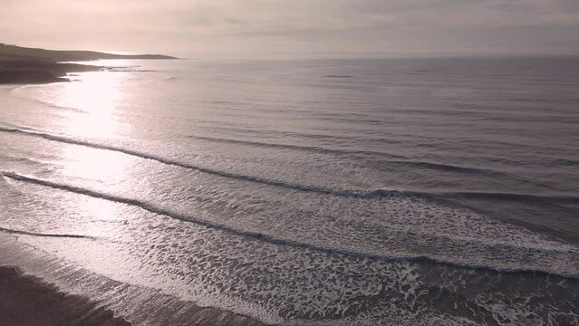 Frozen waves and open horizon with hazy sunshine in winter. An aerial slow motion coastal footage, Ireland